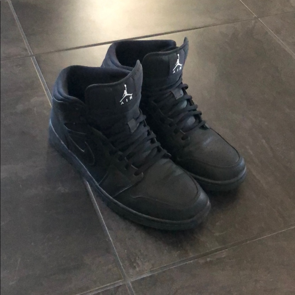 Triple black Jordan 1’s midtop.